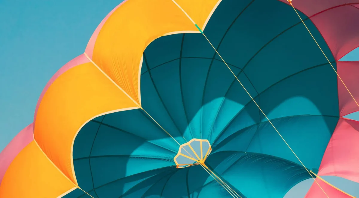 Close-up of a colorful parachute with blue, yellow, and pink panels against a clear sky – Symbolizing financial security, protection, and planning in Meridian, ID.